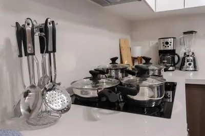 a kitchen counter with pots and pans on a stove at Lovely Aparment OceanView Barranco1809 in Lima
