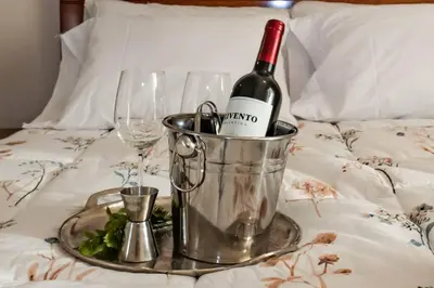 a bottle of wine in a bucket on a bed at Lovely Aparment OceanView Barranco1809 in Lima