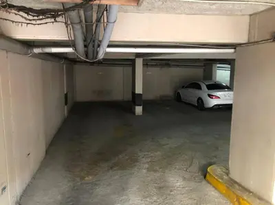 a parking garage with a car parked in it at (26) Departamento cómodo y tranquilo en Miraflores in Lima