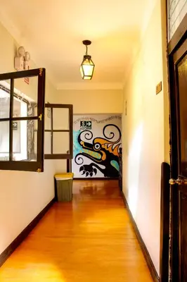 an empty hallway with a painting on the wall at Bear Packer Hostel in Cusco