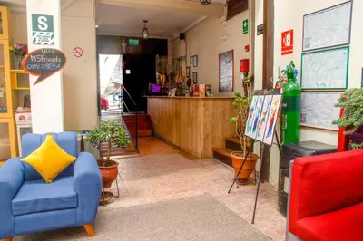 a waiting room with chairs and a counter at Bear Packer Hostel in Cusco