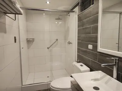 a bathroom with a shower and a toilet and a sink at LA TERRAZA INN in Huancavelica