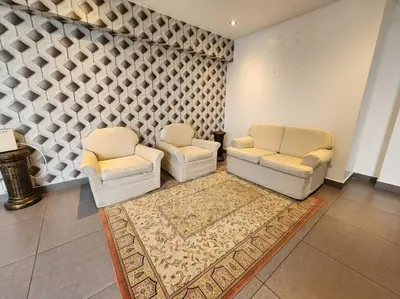 a living room with two chairs and a rug at R&M Apartament in Lima