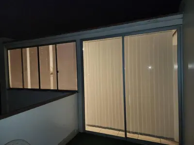 two windows in a room with blinds on them at R&M Apartament in Lima