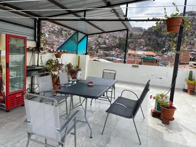 a table and chairs on a patio with a view at Adriano's Deluxe Apartments 1 in Cusco