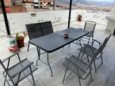 a black table and chairs sitting on a roof at Adriano's Deluxe Apartments 1 in Cusco