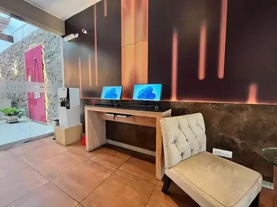 a office with two computers on a desk with a chair at Hotel El Tambo 2 in Lima