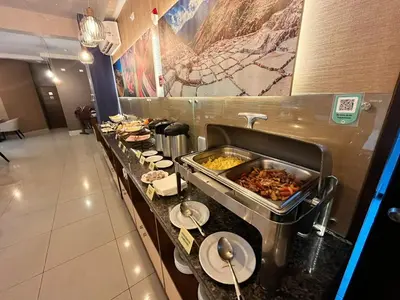 a buffet line in a restaurant with food on it at Hotel El Tambo 2 in Lima