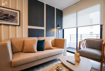 a living room with a couch and a chair at The Classic by Wynwood House in Lima