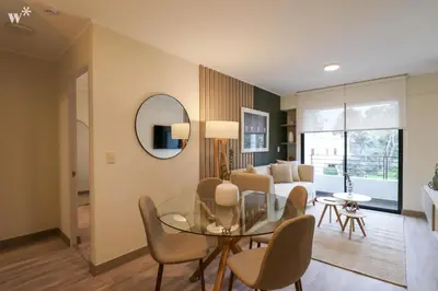 a living room with a glass table and chairs at The Classic by Wynwood House in Lima