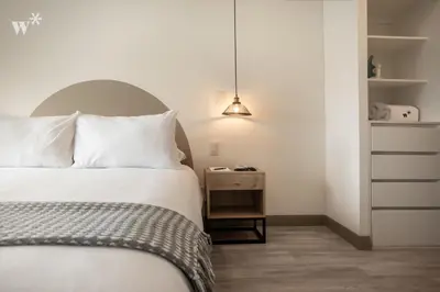 a bedroom with a bed and a nightstand next to a bed sidx sidx sidx at The Classic by Wynwood House in Lima
