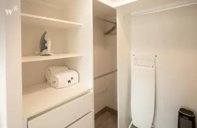 a bathroom with white shelves and a refrigerator at The Classic by Wynwood House in Lima