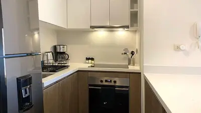 a small kitchen with a sink and a stove at The Classic by Wynwood House in Lima