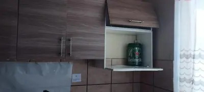a bottle of beer in a cabinet in a kitchen at depacentrohuancayo in Huancayo