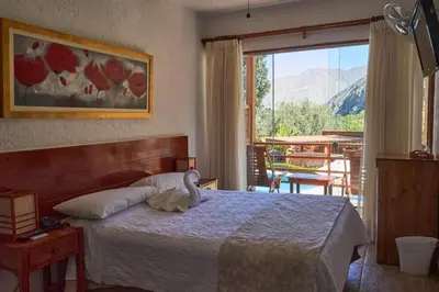 a bedroom with a bed with a swan on it at El Molino Hotel y Restaurant in Lunahuaná
