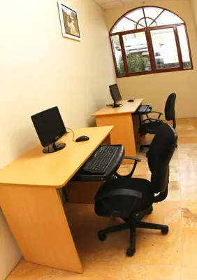 an office with two desks with a computer on them at Lunahuana River Resort in Lunahuaná