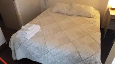 a bed with white sheets and towels on it at Barranco Best Location - Apartment wAC in Lima