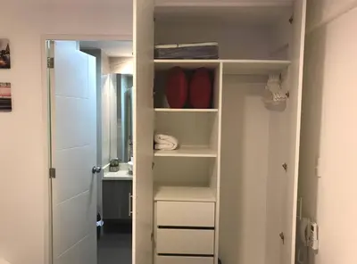a bathroom with a closet with a sink at Barranco Best Location - Apartment wAC in Lima