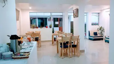 a dining room with a table and chairs in a room at Emmanuel inn Machupicchu in Machu Picchu