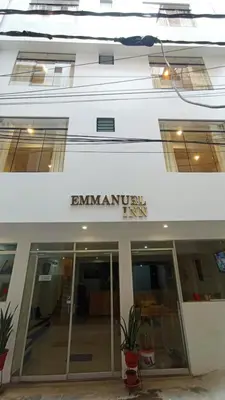 a white building with the entrance to an office at Emmanuel inn Machupicchu in Machu Picchu