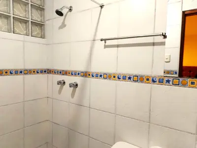 a bathroom with a shower and a toilet at Paqarina San Blas in Cusco
