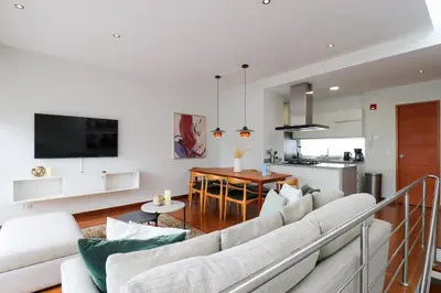 a living room with a couch and a table at Mimosas 145 by Wynwood House in Lima