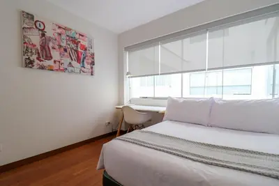 a bedroom with a bed and a window and a desk at Mimosas 145 by Wynwood House in Lima