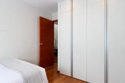 a bedroom with white cabinets and a bed at Mimosas 145 by Wynwood House in Lima