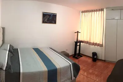 a bedroom with a bed and a dresser and a window at Hermoso Duplex en Chorrillos in Lima