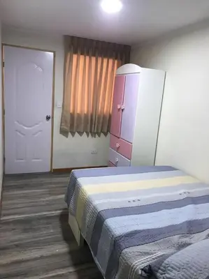 a bedroom with a bed and a dresser and a door at Hermoso Duplex en Chorrillos in Lima