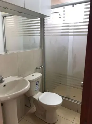 a bathroom with a toilet and a sink and a shower at Hermoso Duplex en Chorrillos in Lima