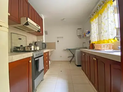 a kitchen with a sink and a stove top oven at Cómodo, céntrico, cerca a Parque Media Luna in Lima