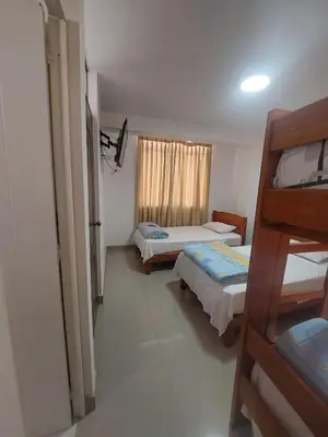 a bedroom with two beds and a window at R. A. C. S. in Paracas