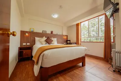 a bedroom with a large bed and a window at Dreams Boutique Hotel Cusco in Cusco