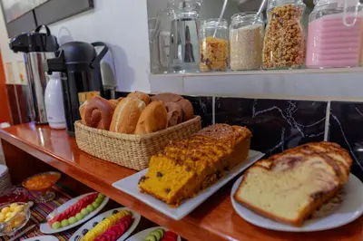 a shelf with different types of bread and pastries at Dreams Boutique Hotel Cusco in Cusco