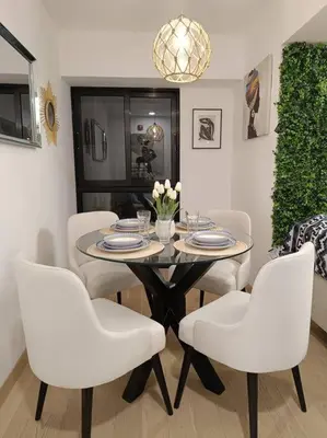 a dining room with a table and white chairs at Runawasi Apartments - Killary Miraflores 2BDR in Lima