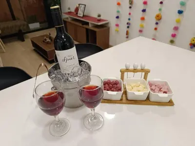 a bottle of wine and two glasses on a table at Runawasi Apartments - Killary Miraflores 2BDR in Lima