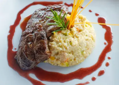 a plate of food with meat and mashed potatoes at Refugio Viñak in Viñak