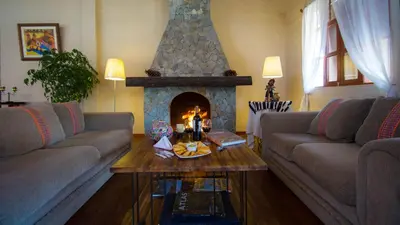 a living room with two couches and a fireplace at Tuki Llajta - Pueblo bonito Lodge in Huancayo