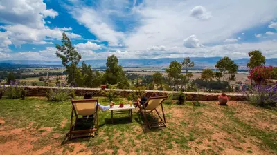 a group of people sitting in chairs around a table at Tuki Llajta - Pueblo bonito Lodge in Huancayo