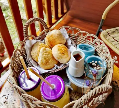 a basket of bread and coffee on a table at La casa del Erizo in Oxapampa