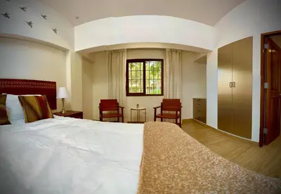 a bedroom with a large white bed and a window at Inkantari Boutique Hotel in Cusco