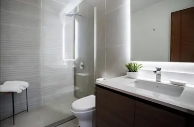 a white bathroom with a sink and a toilet at EL PRAT Luxury Aparment Lima Peru in Lima