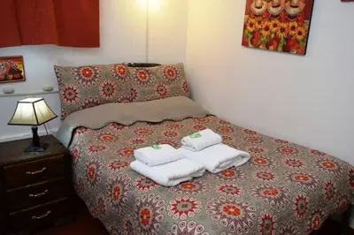 a bedroom with a bed with two towels on it at Carlos Guest House 2 Cusco in Cusco