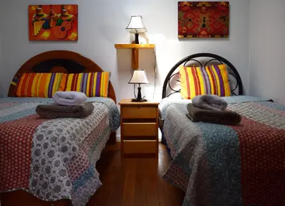 a bedroom with two beds with towels on them at Carlos Guest House 1 Cusco in Cusco