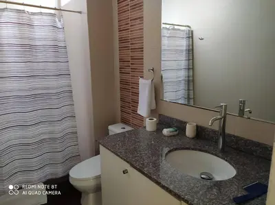 a bathroom with a sink and a toilet and a mirror at New and nice apartment Miraflores in Lima