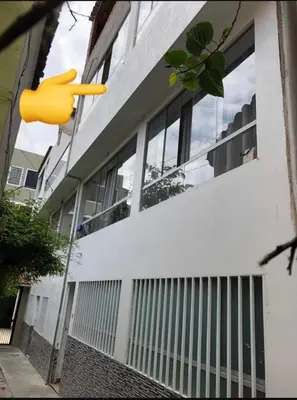 a building with a yellow object hanging off the side of it at Departamento en el centro histórico en 3er y 4to piso in Ayacucho