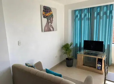 a living room with a couch and a flat screen tv at Departamento en el centro histórico en 3er y 4to piso in Ayacucho
