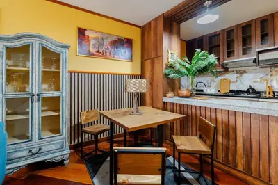 a kitchen with a table and chairs and a counter at Lima Virreinal & primer piso muy acogedor in Lima