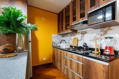 a kitchen with a sink and a microwave at Lima Virreinal & primer piso muy acogedor in Lima